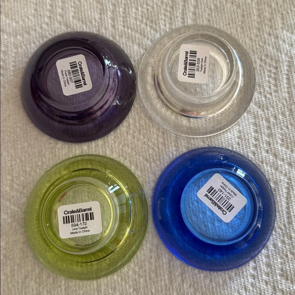 Crate & Barrel set of 4 multicolored tealights cobalt, clear, purple, lime.